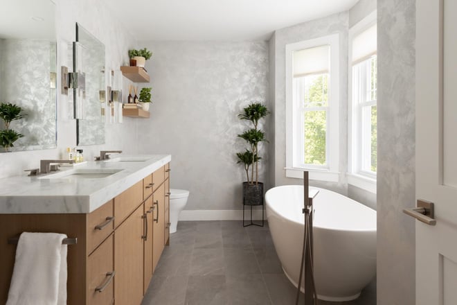 Bathroom remodel in Boston with a wood double vanity, freestanding tub, and bay window, designed by Lee Kimball.