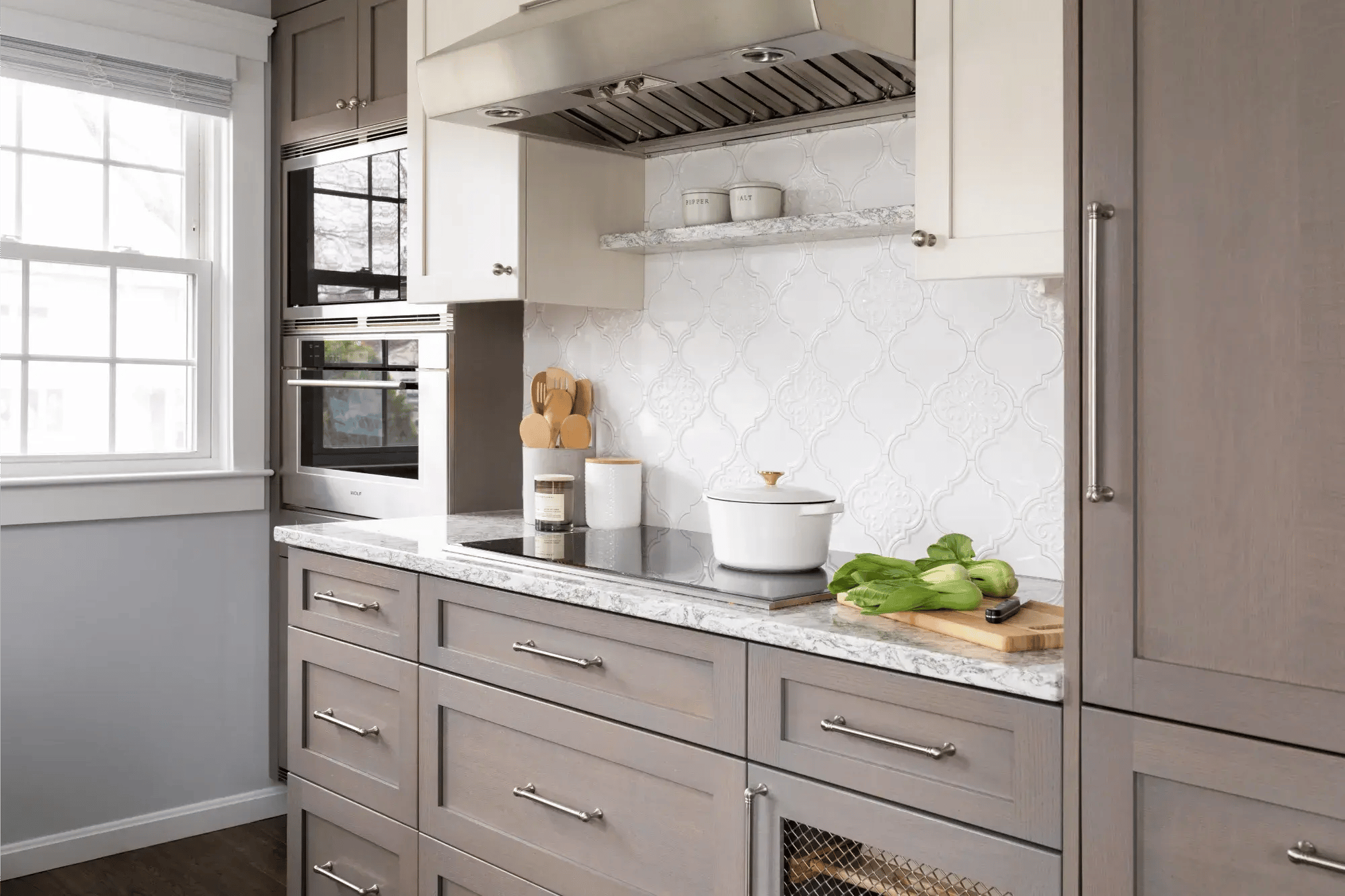 Contemporary kitchen with gray cabinetry and marble backsplash in Greater Boston