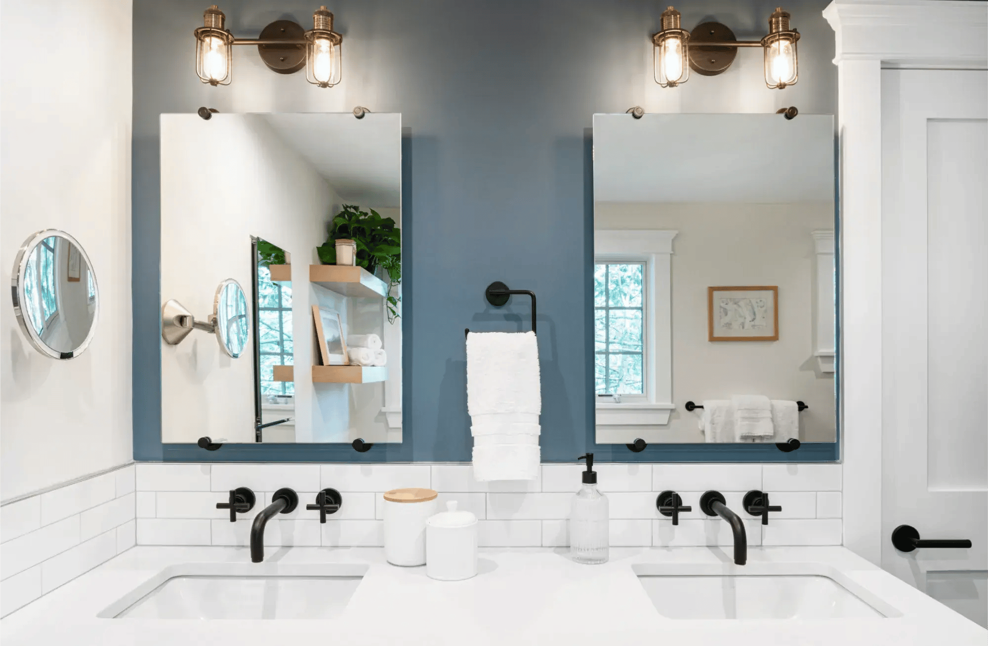 Double vanity bathroom with black fixtures and blue accent wall in Greater Boston