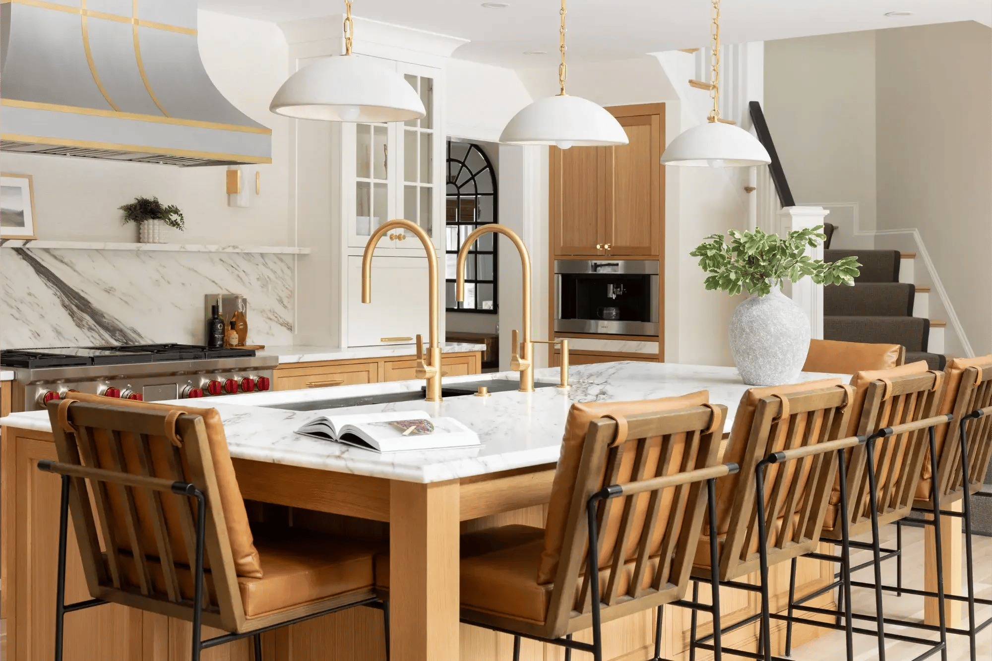 Luxury kitchen with marble island and leather bar stools in Greater Boston
