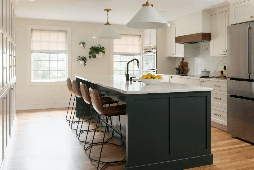 Modern kitchen with dark green island and bar seating in Greater Boston