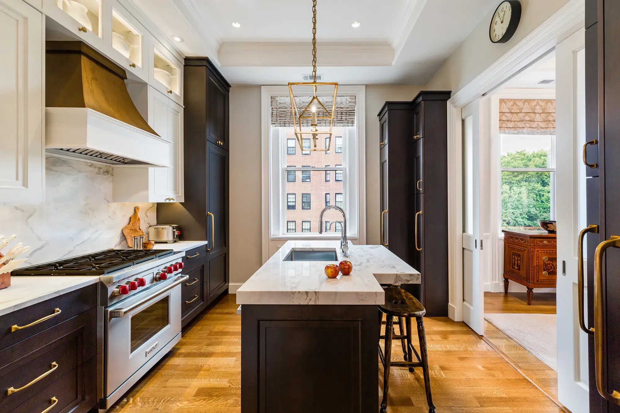 Sophisticated kitchen with dark cabinetry and marble island in Greater Boston