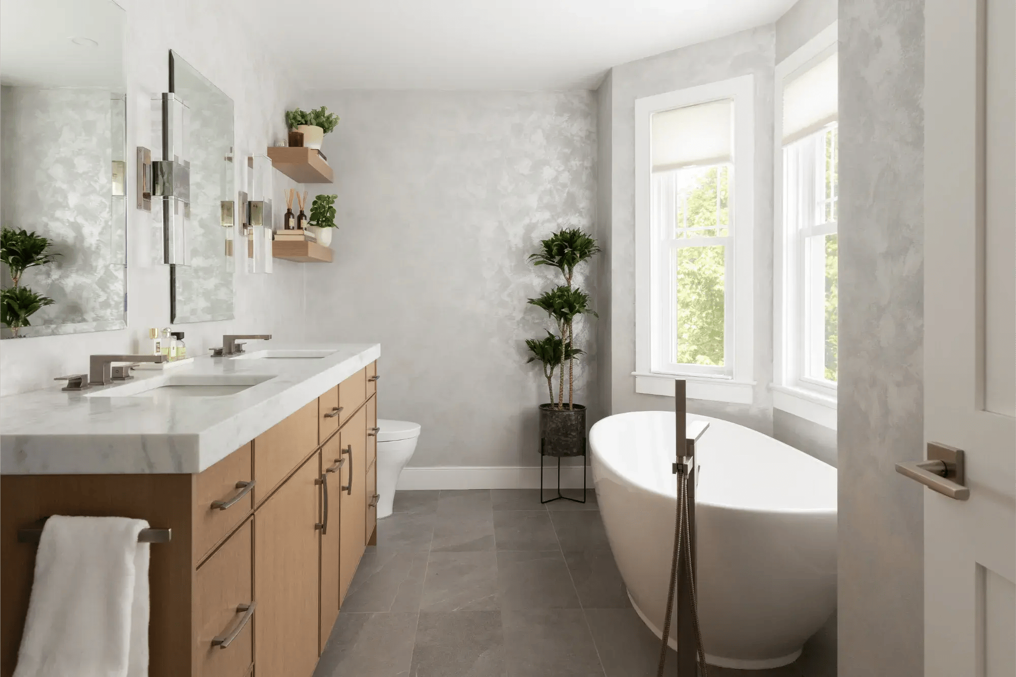 Modern bathroom in Greater Boston with freestanding tub, double vanity, and bright natural light