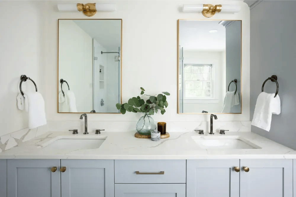 Crisp light blue double vanity with undermount sinks and bronze hardware in Boston, MA