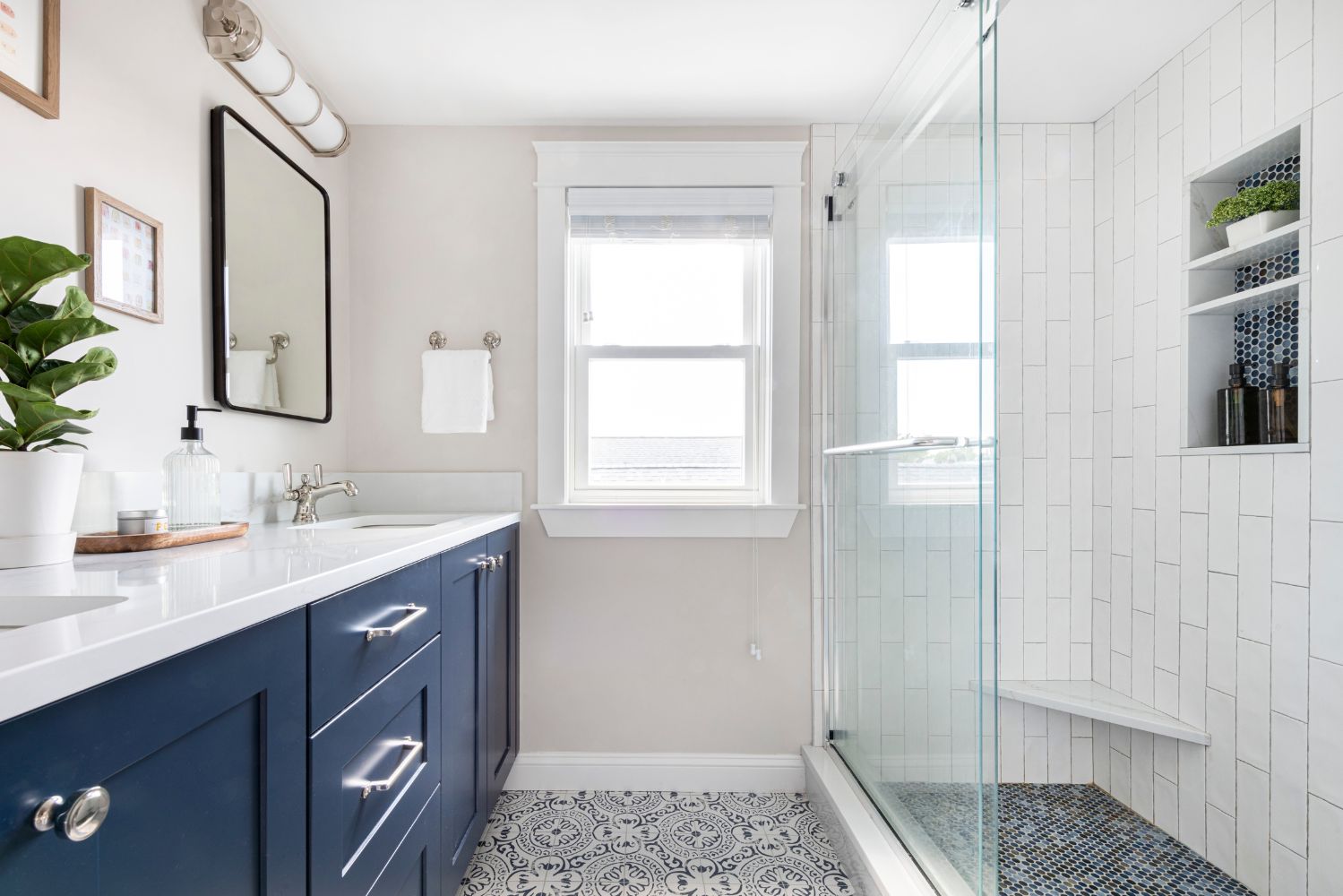 primary suite bathroom remodel blue vanity white tile shower